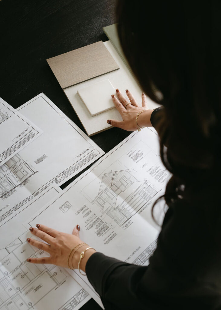 Calgary brand photography with a woman laying out swatches of material.