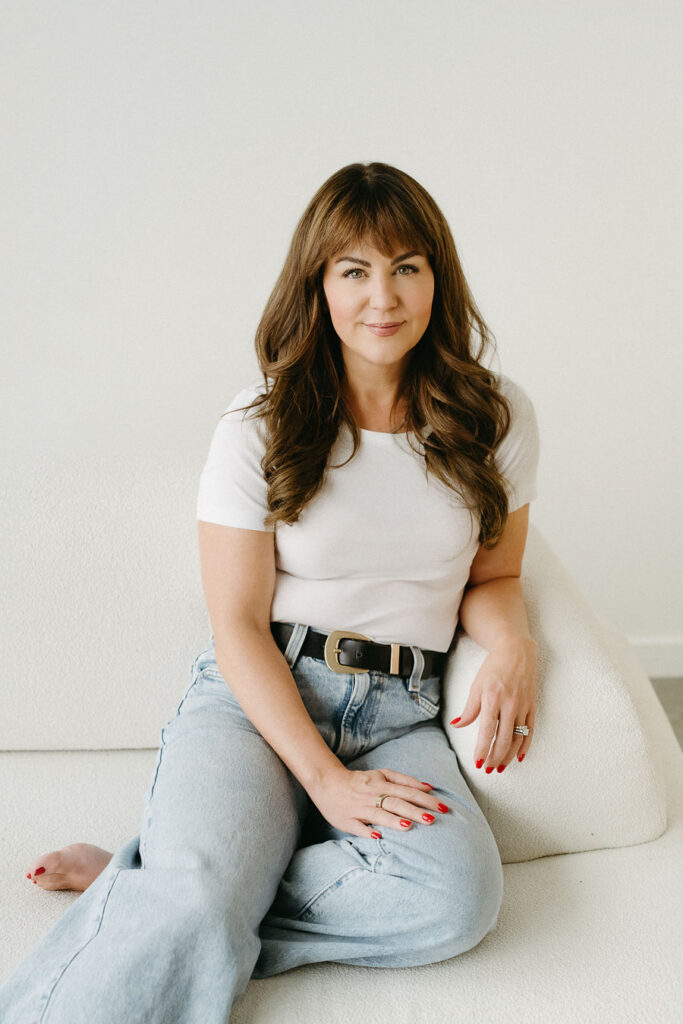 A woman sitting on a chair in her Calgary branding photography shoot.