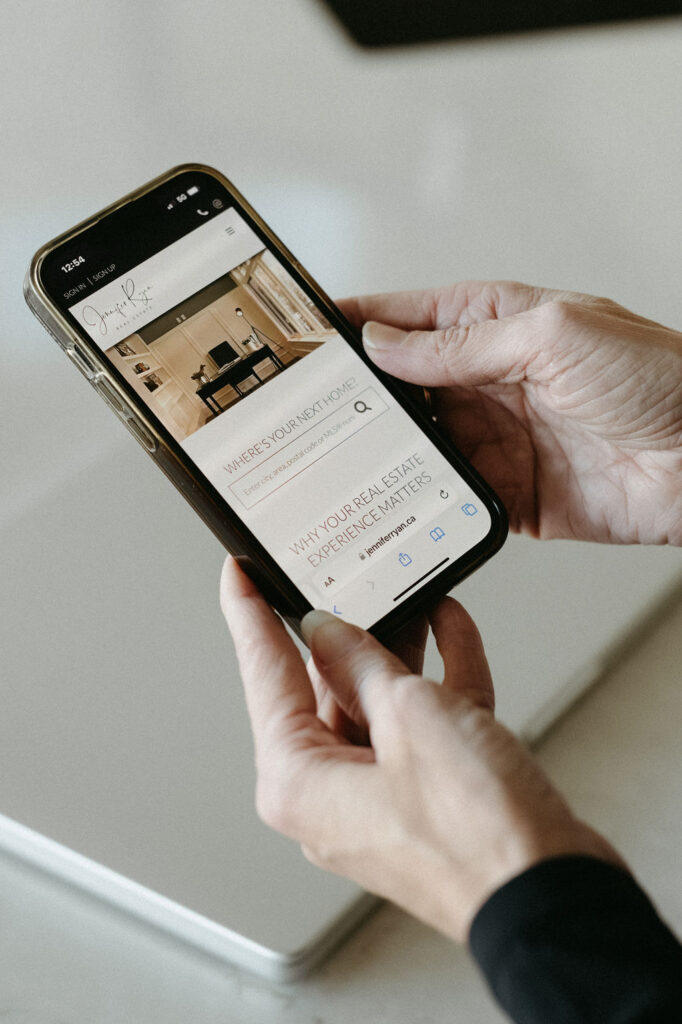 A woman holding a phone while in a branding session in Calgary.