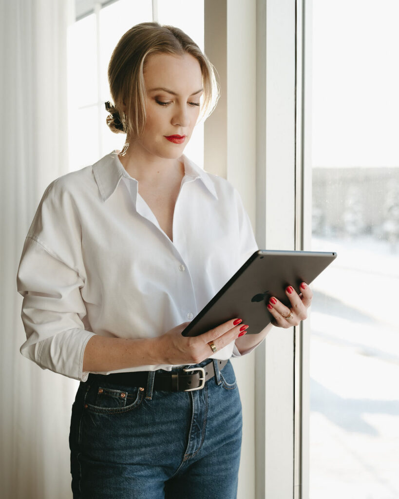 Calgary branding session with a woman holding an ipad in a studio.