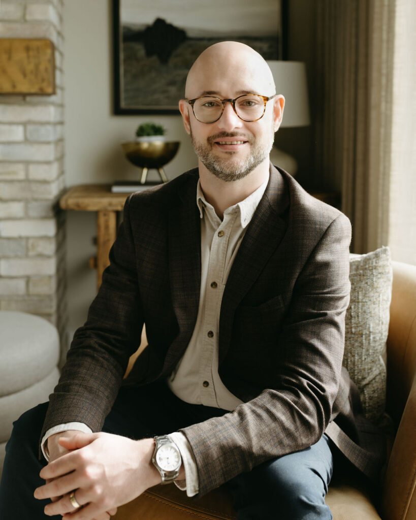 A man sitting on a couch in his office.