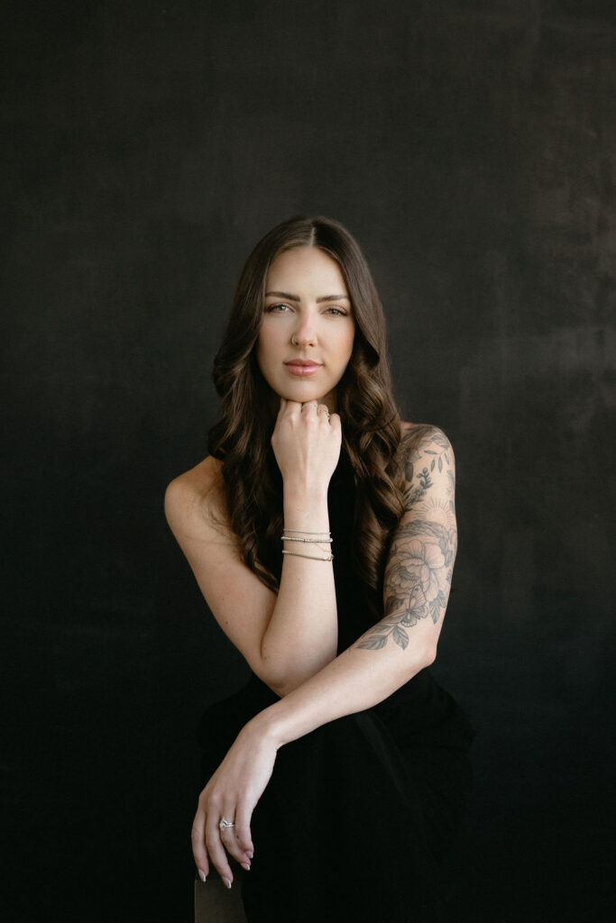 A woman having her portrait taken in a studio by Calgary headshot photographer, Marwa Hurley.