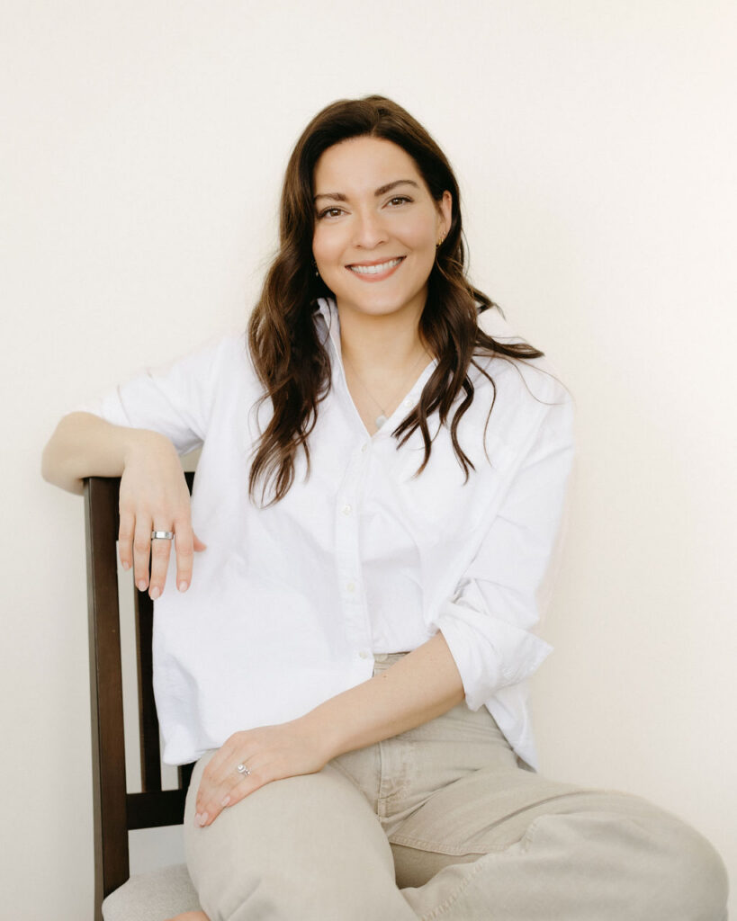 A woman having her portrait while sitting in a chair by Calgary headshot photographer, Marwa Hurley.