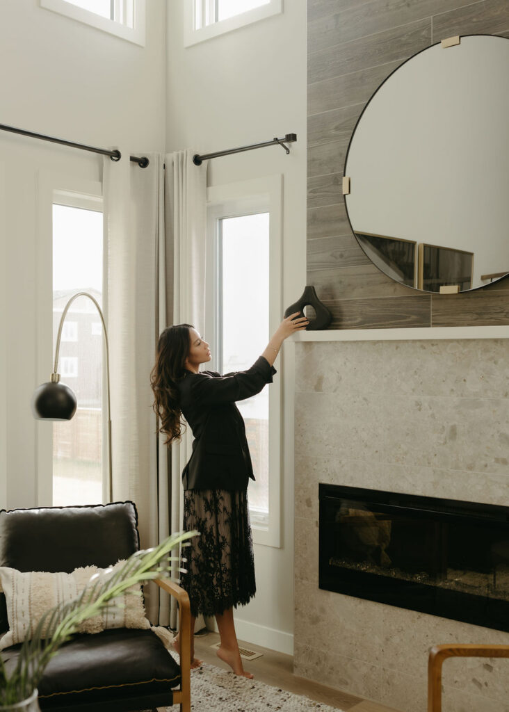 A woman in a showhome in Calgary having her portrait taken. 