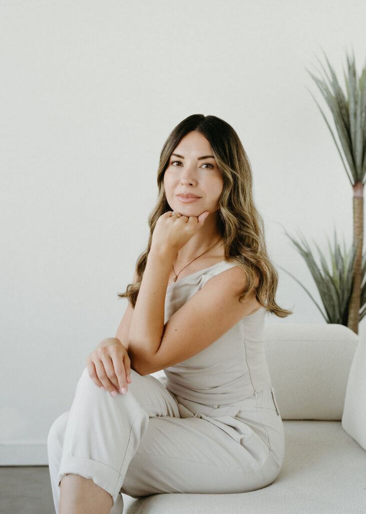A woman in a bright studio in Calgary, Alberta having her headshot taken.