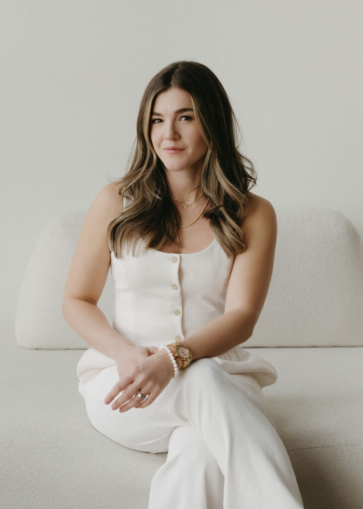 A woman sitting in a chair in a white studio in Calgary, Alberta.