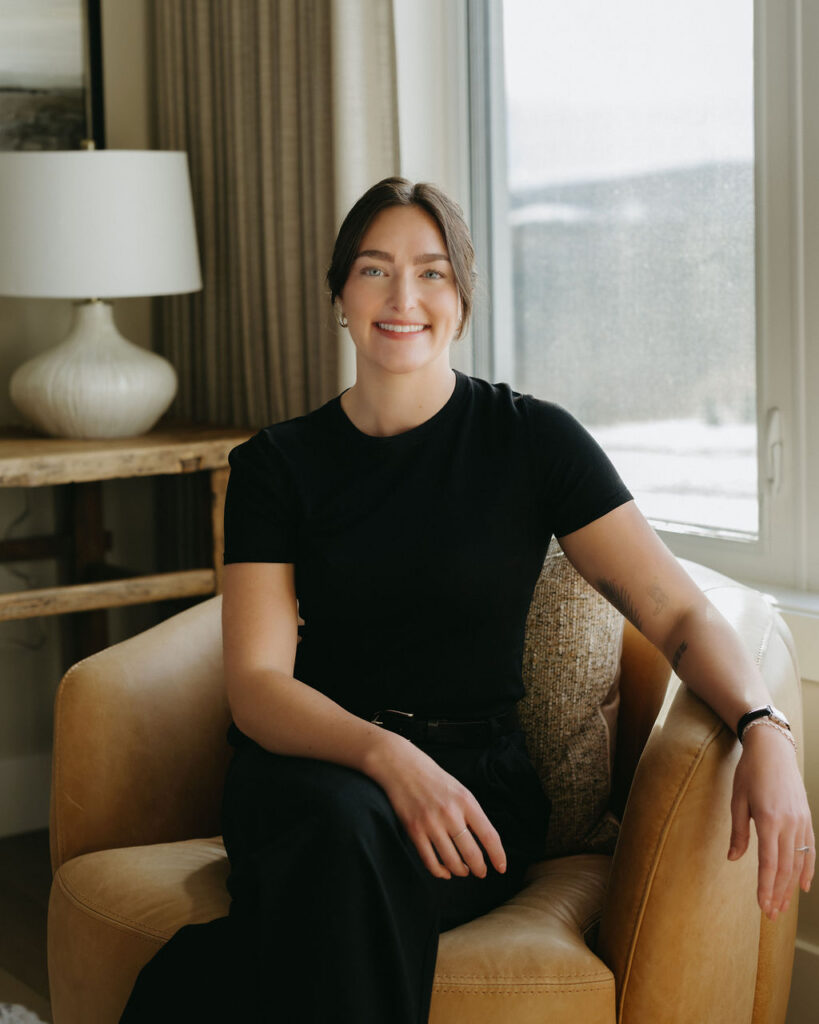 A woman sitting in a chair having her photo taken in Calgary, Alberta.