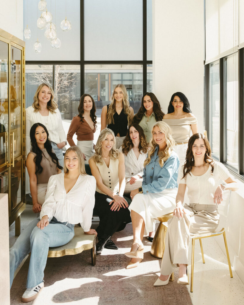 A group of woman in an office having their portraits taken. 